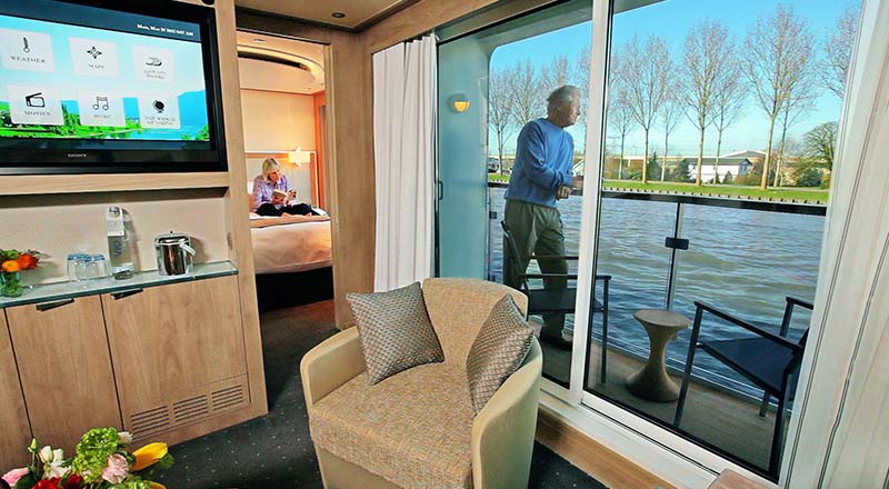 Man looking out from the veranda of a Viking river ship stateroom